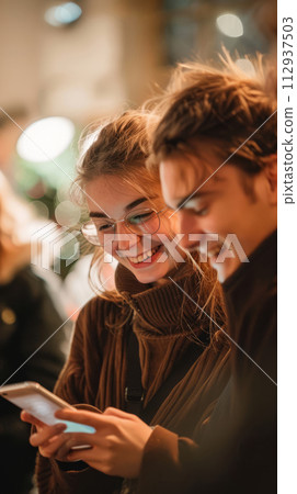 Group of young people looking at smartphone and smiling, social media concept 112937503