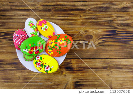 Egg shaped easter gingerbread cookies on wooden table. Top view. Sweets for celebrate Easter Egg shaped easter gingerbread cookies on wooden table. Top view. Sweets for celebrate Easter 112937698