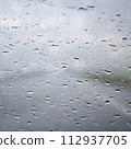 Raindrops on a window glass in summer 112937705