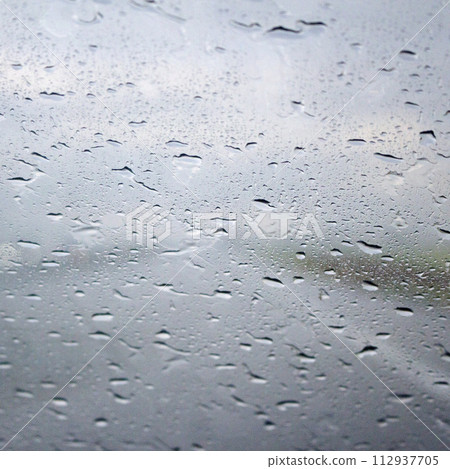 Raindrops on a window glass in summer 112937705