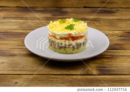 Traditional russian salad Mimosa on wooden table 112937716