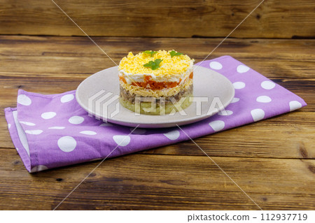Traditional russian salad Mimosa on wooden table 112937719