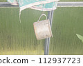 Old rusty tin mug hanging on a peg 112937723