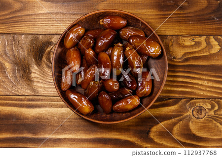 Dried dates fruit on wooden table. Top view Dried dates fruit on wooden table. Top view 112937768