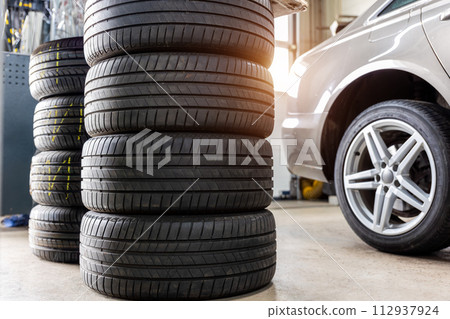Car wheel repair with two auto lift back view. Seasonal winter tyre change at workshop. Vehicle tire repair, inspection maintenance. Automotive garage for replace spare parts after failure breakdown Car wheel repair with two auto lift back view. Seasonal winter tyre change at workshop. Vehicle tire repair, inspection maintenance. Automotive garage for replace spare parts after failure breakdown 112937924