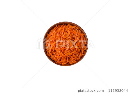 Tasty spicy Korean carrot with spices and herbs on a dark concrete background 112938044