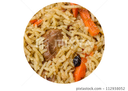Delicious pilaf with vegetables, salt, spices and herbs in a ceramic plate 112938052