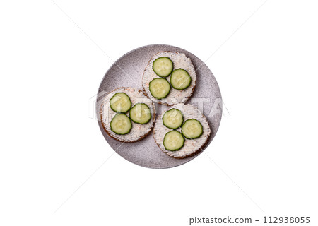Delicious vegetarian sandwich with grilled toast, cream cheese, cucumbers and seeds Delicious vegetarian sandwich with grilled toast, cream cheese, cucumbers and seeds 112938055