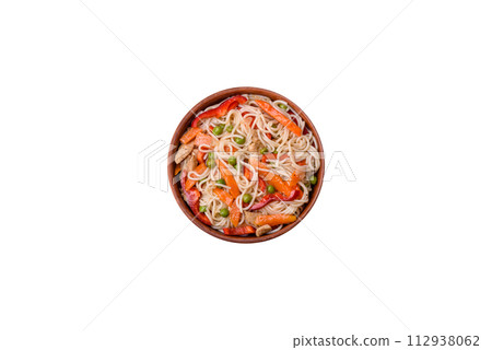Delicious rice noodles or udon with chicken, carrots, pepper, salt, spices and herbs 112938062