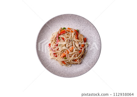 Delicious rice noodles or udon with chicken, carrots, pepper, salt, spices and herbs 112938064