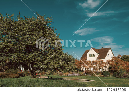 House with nice garden in fall. Flowers in the City Park of Bietigheim-Bissingen, Baden-Wuerttemberg, Germany, Europe. Autumn Park and house, nobody, bush and grenery House with nice garden in fall. Flowers in the City Park of Bietigheim-Bissingen, Baden-Wuerttemberg, Germany, Europe. Autumn Park and house, nobody, bush and grenery 112938308