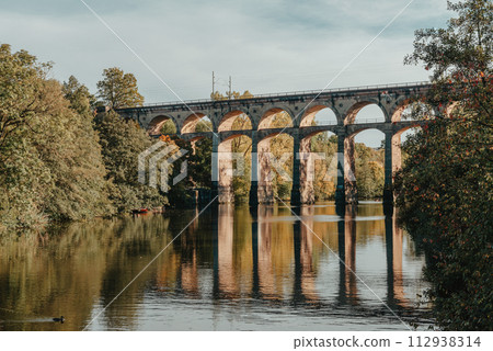 Railway Bridge with river in Bietigheim-Bissingen, Germany. Autumn. Railway viaduct over the Enz River, built in 1853 by Karl von Etzel on a sunny summer day. Bietigheim-Bissingen, Germany. Old Railway Bridge with river in Bietigheim-Bissingen, Germany. Autumn. Railway viaduct over the Enz River, built in 1853 by Karl von Etzel on a sunny summer day. Bietigheim-Bissingen, Germany. Old 112938314