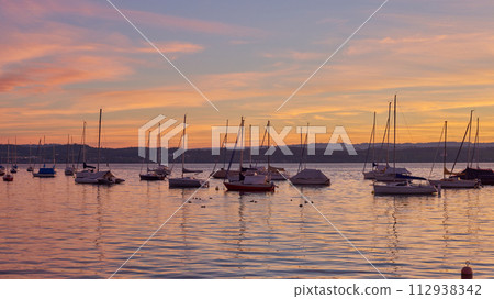 Bodensee Lake Sunrise Panorama. Morning Sunlight Over Tranquil Waters. Bodensee Lake Sunrise Panorama. Morning Sunlight Over Tranquil Waters. 112938342