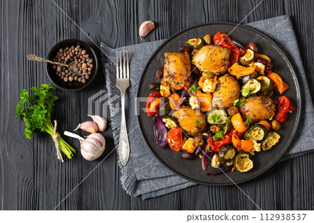 baked chicken thighs with veggies, olives, feta 112938537