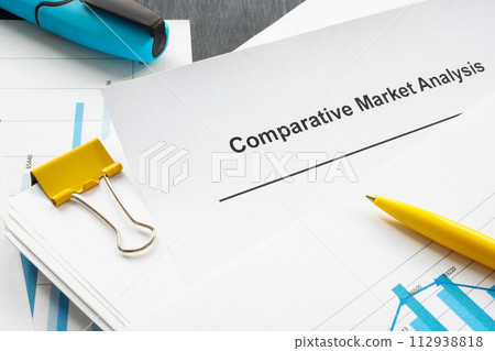 A comparative market analysis report from a stack of papers with graphs. A comparative market analysis report from a stack of papers with graphs. 112938818