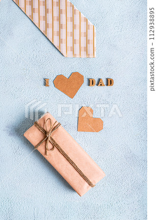 Father's day craft gift, tie, heart and inscription on a blue background vertical view Father's day craft gift, tie, heart and inscription on a blue background vertical view 112938895