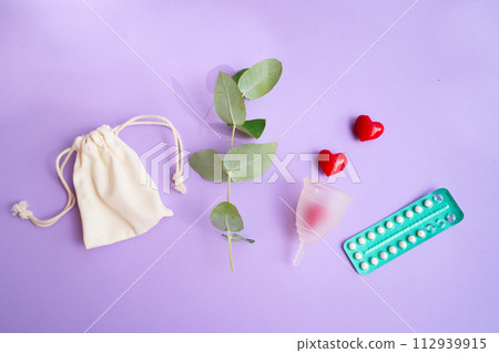 Menstrual cap over violet background Menstrual cap over violet background 112939915