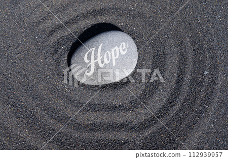 Hope stone on black sand Hope stone on black sand 112939957