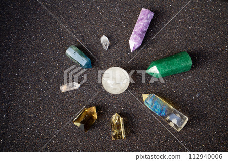 Healing crystals on black sand background 112940006