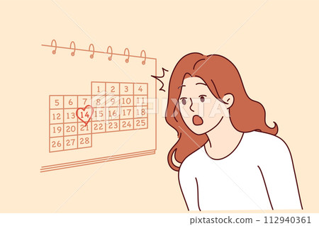 Woman learns about valentine day on february 14th and feels shocked standing near wall with calendar 112940361