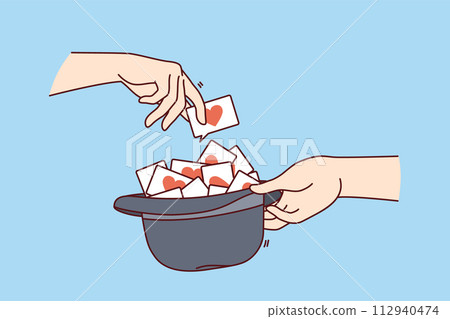 Love notes or wishes inside hat and hands of people playing romantic game for spouses Love notes or wishes inside hat and hands of people playing romantic game for spouses 112940474