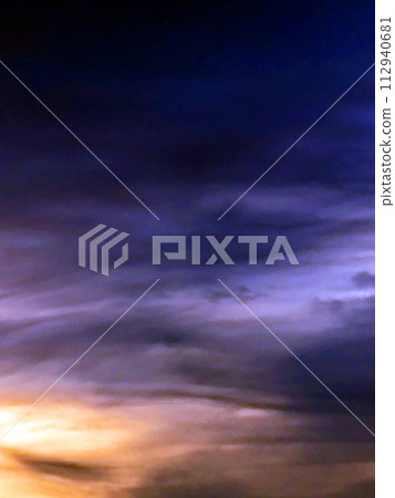 Dramatic Dark Forboading Sunset Clouds Abstract Blues and Yellows in the Sky 112940681