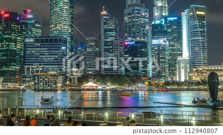 Singapore business district skyscrapers in the night time with water reflections timelapse 112940807