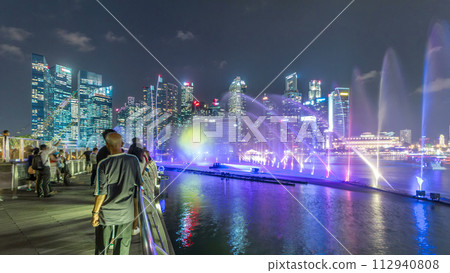Light and Water Show along promenade in front of Marina Bay Sands timelapse 112940808
