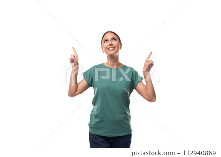 young brunette woman in a t-shirt points with her hand to the side on an empty space young brunette woman in a t-shirt points with her hand to the side on an empty space 112940869