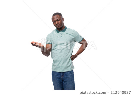 portrait of a young positive short-haired american man dressed in a mint summer t-shirt on a white 112940927