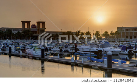 Yachts and boats at the Sharq Marina at sunset timelapse in Kuwait. Kuwait City, Middle East Yachts and boats at the Sharq Marina at sunset timelapse in Kuwait. Kuwait City, Middle East 112941048