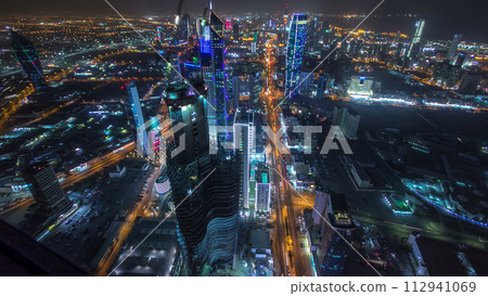 Skyline with Skyscrapers night timelapse in Kuwait City downtown illuminated at dusk. Kuwait City, Middle East 112941069