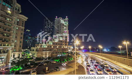 Moving cars traffic on night road in modern city Dubai timelapse hyperlapse 112941173