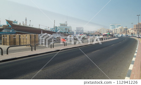 Ship loading timelapse along Deira's shore of Dubai Creek, UAE. 112941226