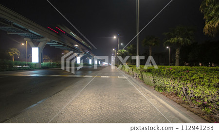Road and tunnel on the Palm Jumeirah island in Dubai at night, UAE timelapse Road and tunnel on the Palm Jumeirah island in Dubai at night, UAE timelapse 112941233