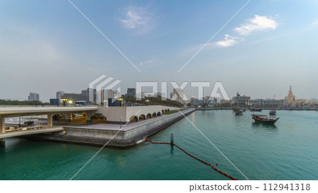 View of the Doha city in front of the Museum of Islamic Art day to night timelapse in the Qatari capital, Doha. 112941318