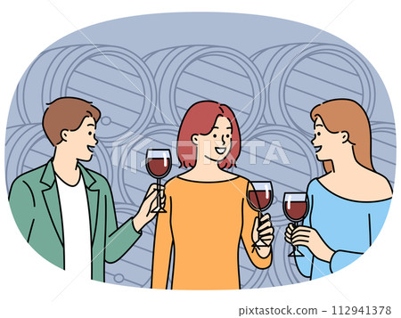 Smiling people tasting wine in cellar Smiling people tasting wine in cellar 112941378