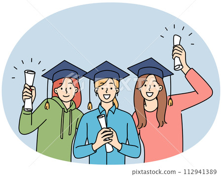 Happy girls holding graduation diplomas 112941389
