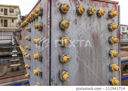 Numerous bolts on railway catenary struts Numerous bolts on railway catenary struts 112941724