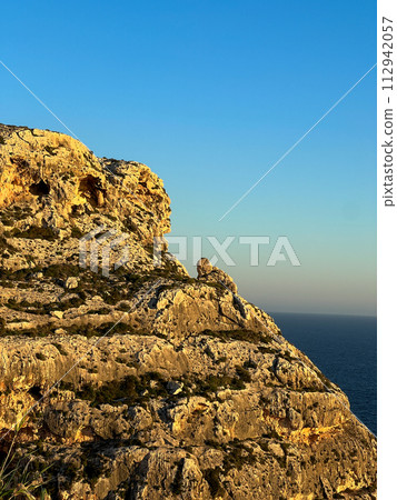 Beautiful sunset at Blue Grotto , complex of seven caves found along the southern coast of Malta. Beautiful sunset at Blue Grotto , complex of seven caves found along the southern coast of Malta. 112942057
