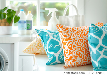 Stack of clean towels on modern washing machine with blurred background. The towels showcasing soft and fluffy textures 112942849