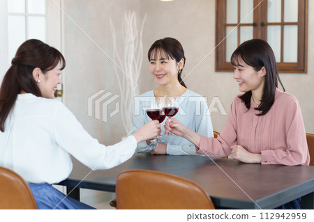 A woman toasting at a restaurant A woman toasting at a restaurant 112942959