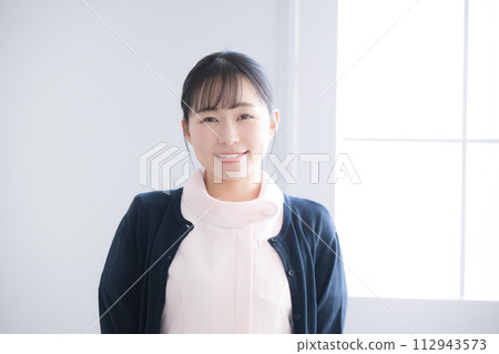 Image of a young female nurse looking at the camera Image of a young female nurse looking at the camera 112943573