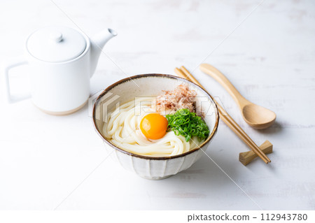 udon noodle with green onion, bonito powder and egg yolk 112943780
