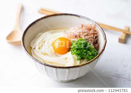 udon noodle with green onion, bonito powder and egg yolk 112943781