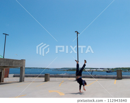 Man Handstands on top of a parking garage the City of Portland Maine 112943840