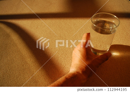 hand holding a glass hand holding a glass 112944195