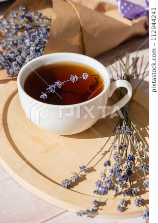 Healthy homemade cup of lavender tea. Organic natural home grown herb for teas. White cup of tea with dried lavender flowers. Healthy living wellbeing 112944241