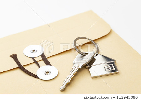 String envelope and house key on white background String envelope and house key on white background 112945086