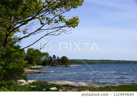 Rocky coast with pier on Littlejohn Island 112945684